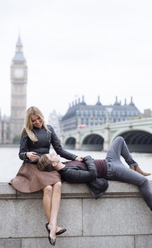 Romantic young couple on wall in front of Big Ben, London, England, UK